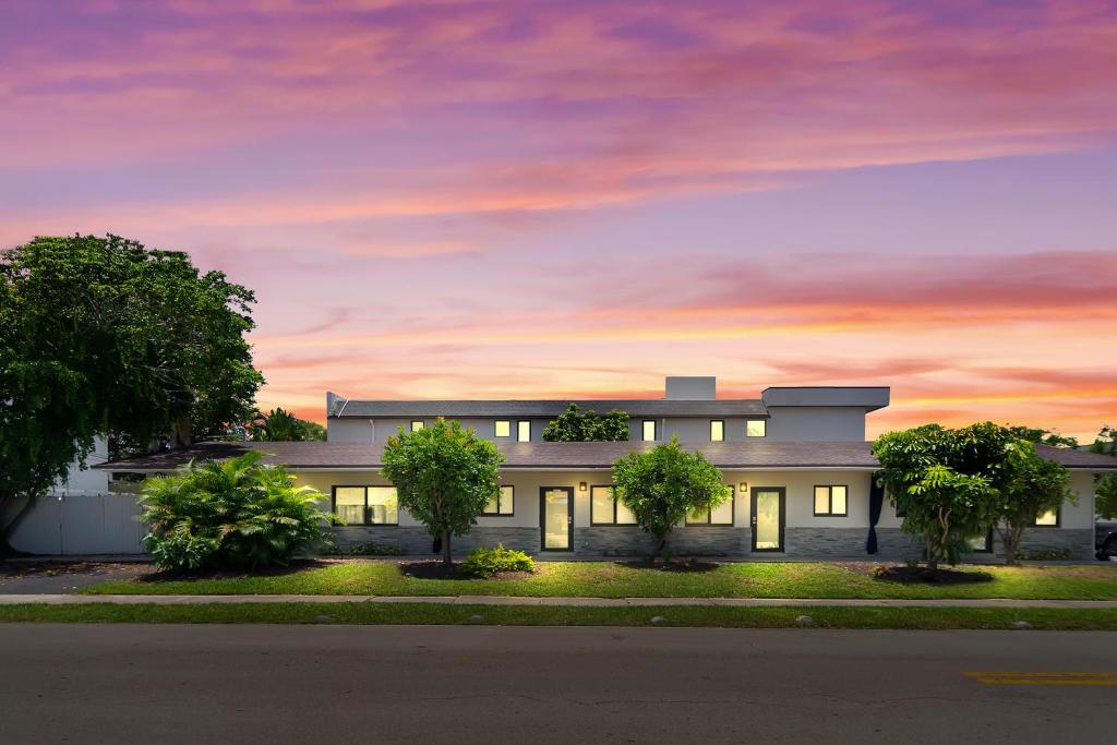 a building with a sunset in the background at Alani Bay Condos in Fort Lauderdale