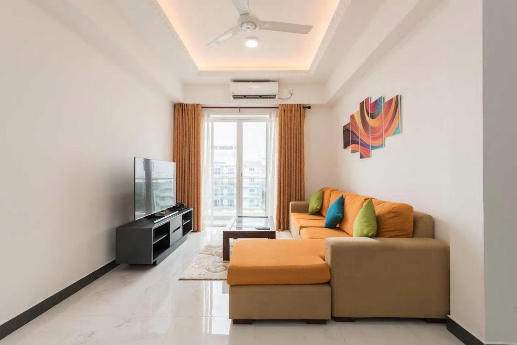 - un salon avec un canapé et une télévision dans l'établissement Fully Furnished 2 Bedroom Apartment with Sea View, à Dehiwala-Mont Lavinia