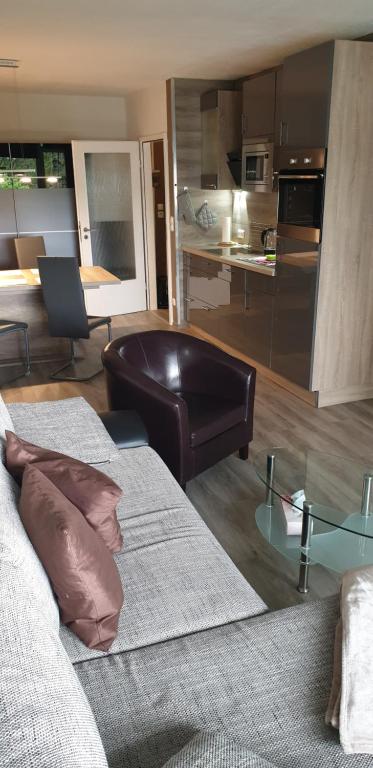 a living room with two beds and a kitchen at Hahnenklee Ferienpark 1-411 in Hahnenklee-Bockswiese