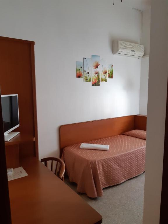 Postel nebo postele na pokoji v ubytování Hotel Rosa