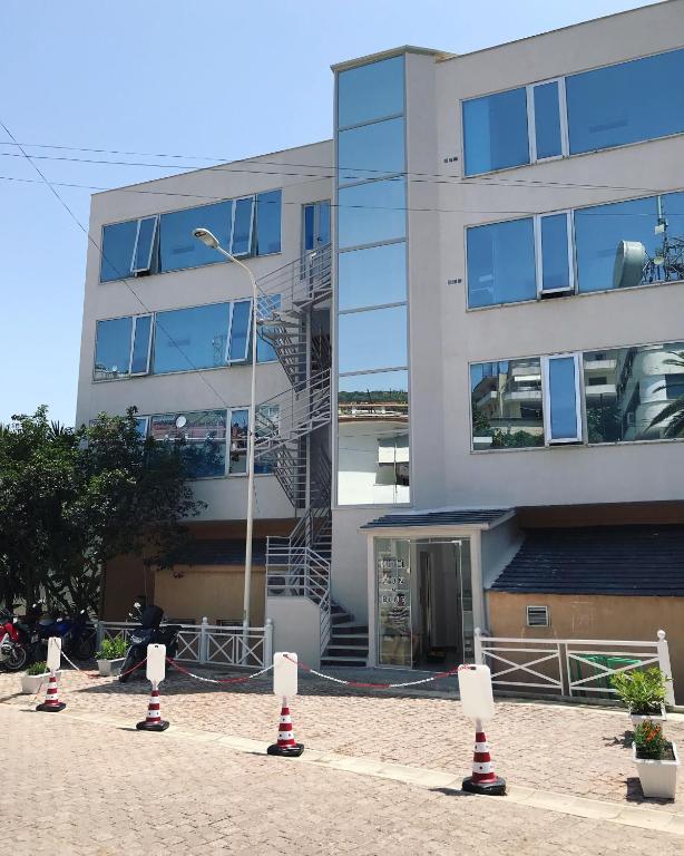 a building with red and white cones in front of it at Sun N Blue Hotel in Sarandë