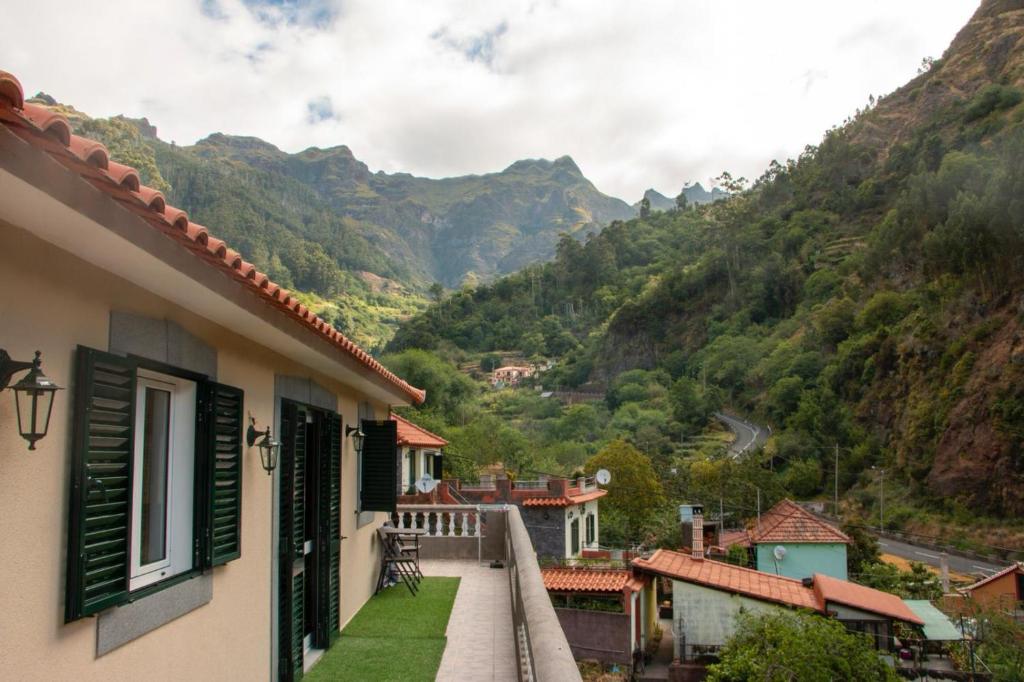 a scenic view of a town with a mountain range at Danny's Rural Suite in Curral das Freiras