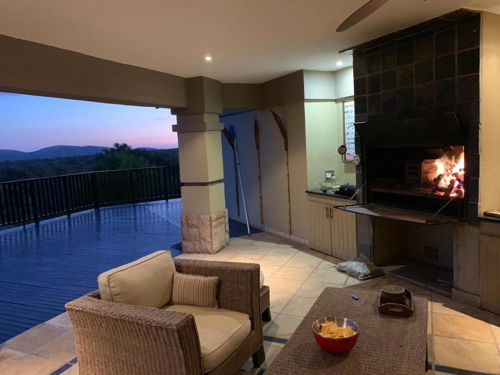 a living room with a fireplace and a couch at Elements golf reserve in Bela-Bela