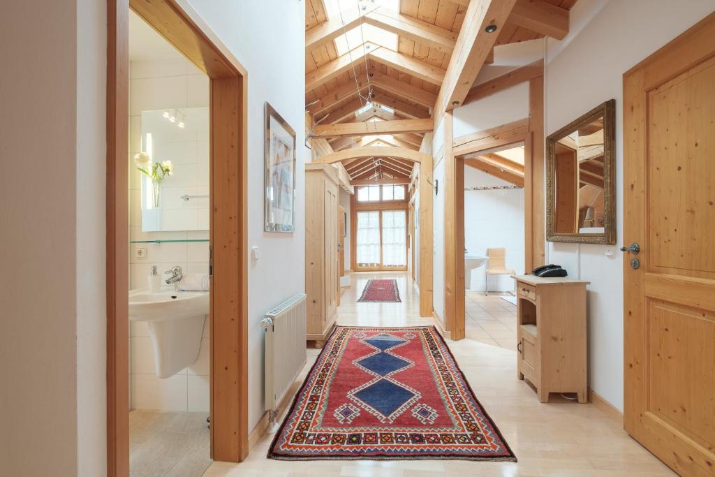 a bathroom with a rug on the floor at Die Edelraute in Oberstdorf