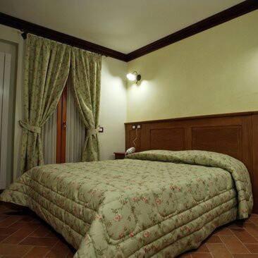 Łóżko lub łóżka w pokoju w obiekcie B&B IL PINO