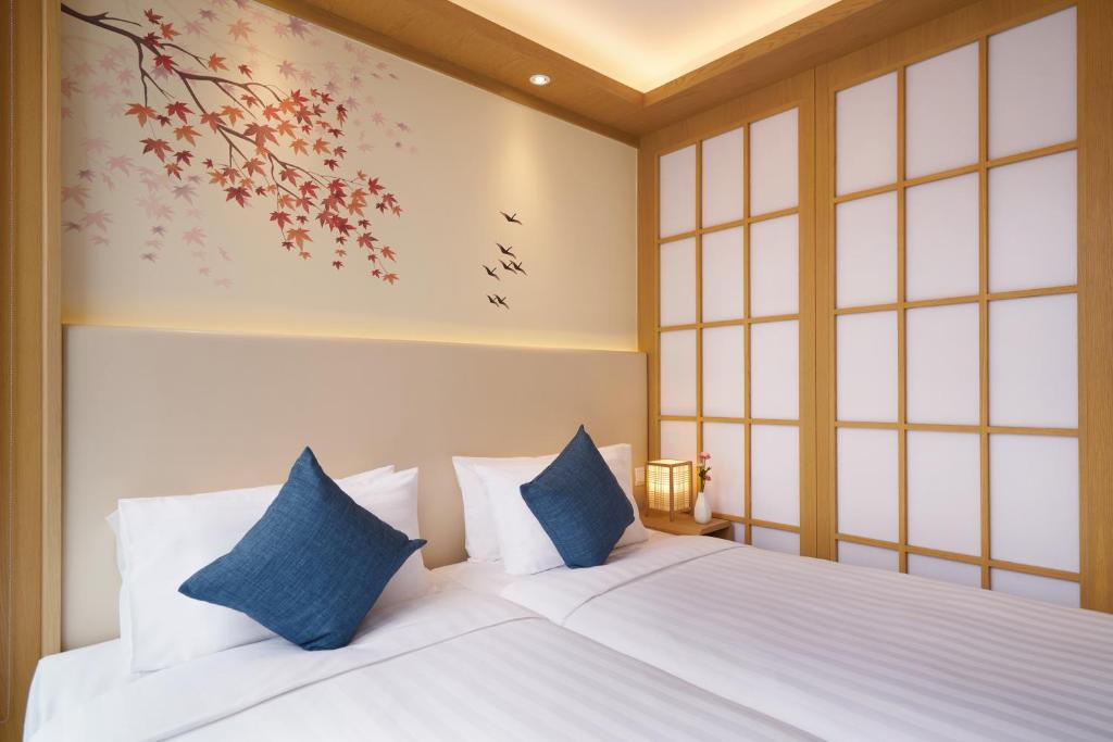 Postel nebo postele na pokoji v ubytování Hotel COZi Resort Tuen Mun