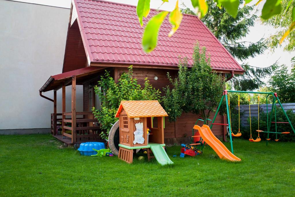 a small house with a playground and a play structure at Domek we Władku in Władysławowo