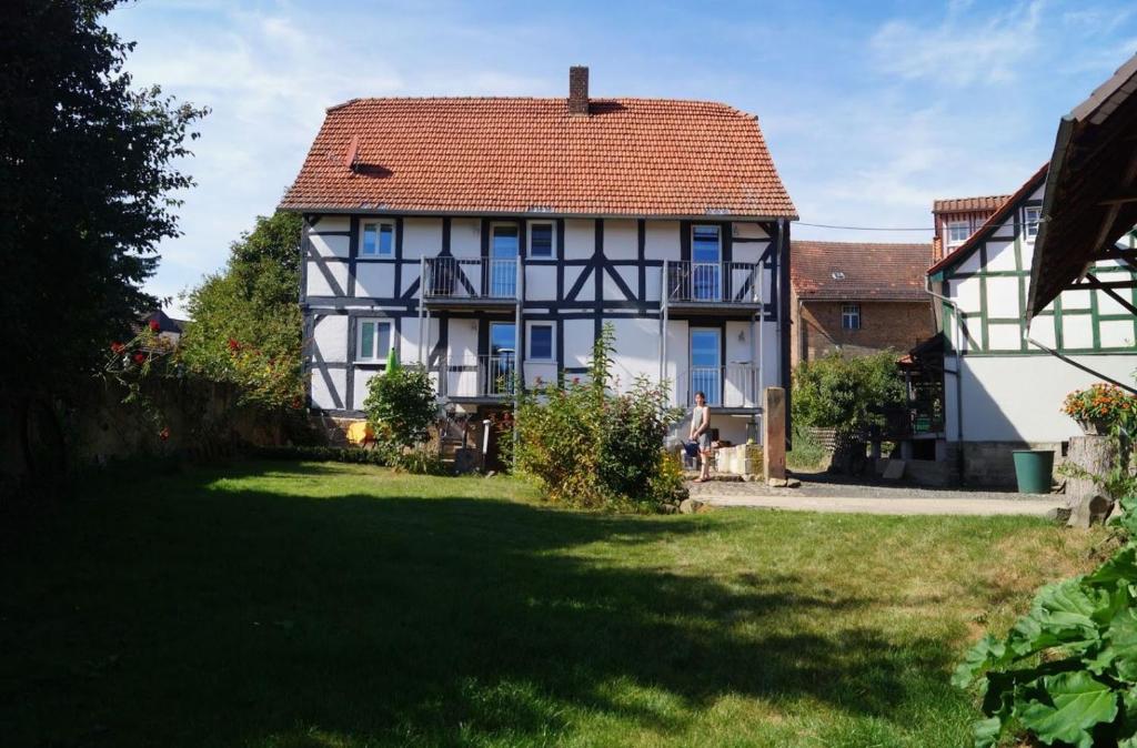 a white and black house with a red roof at Gästehaus Minkel in Gudensberg