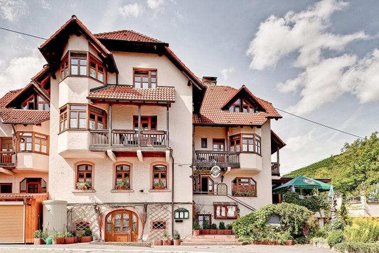 a large white house with at Hotel Adler in Lauda-Königshofen