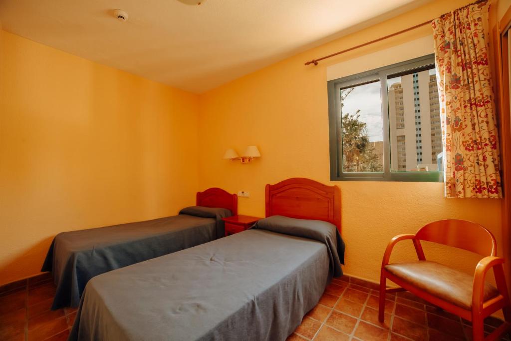Postel nebo postele na pokoji v ubytování Apartamentos Palm Court