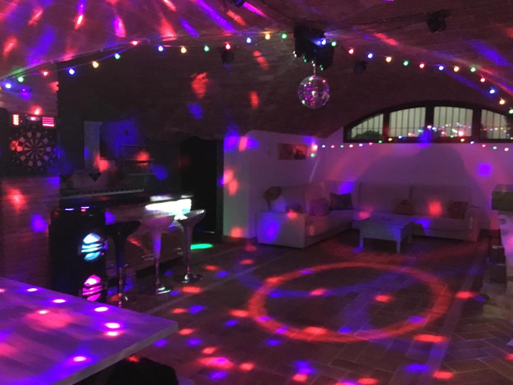 een kamer met paarse en paarse lichten en een dansvloer bij Villa Skyline Alhambra-Nevada in La Zubia