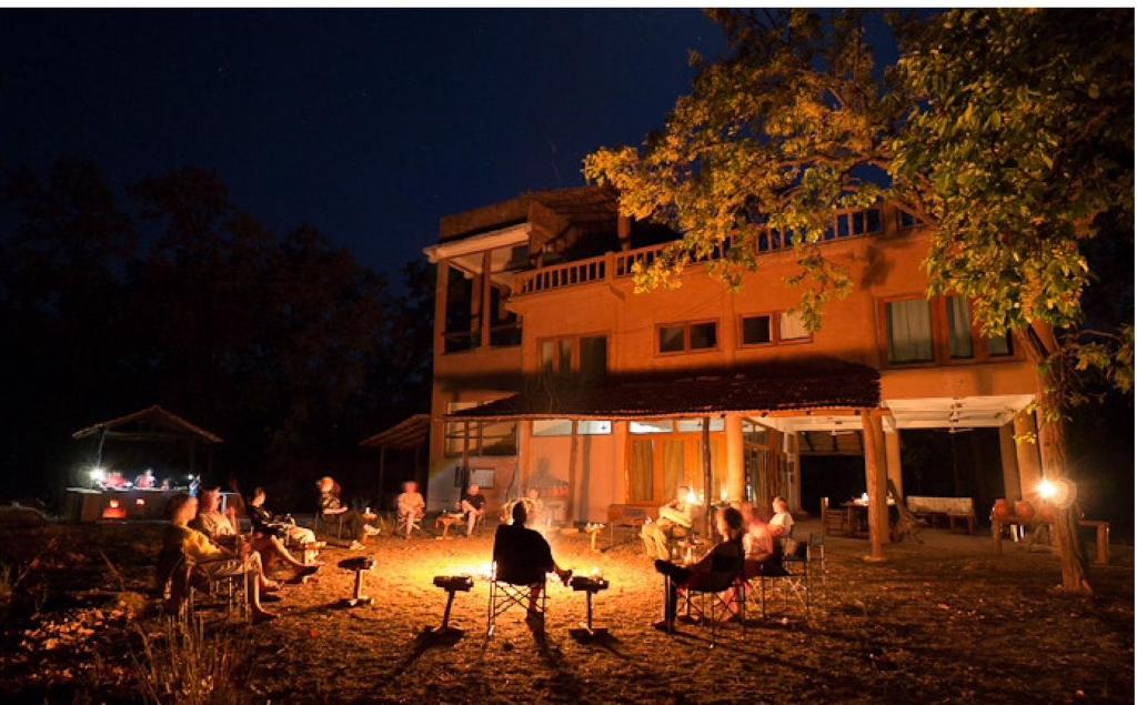 a group of people sitting in chairs in front of a building at Emerald Tiger Retreat in Tāla
