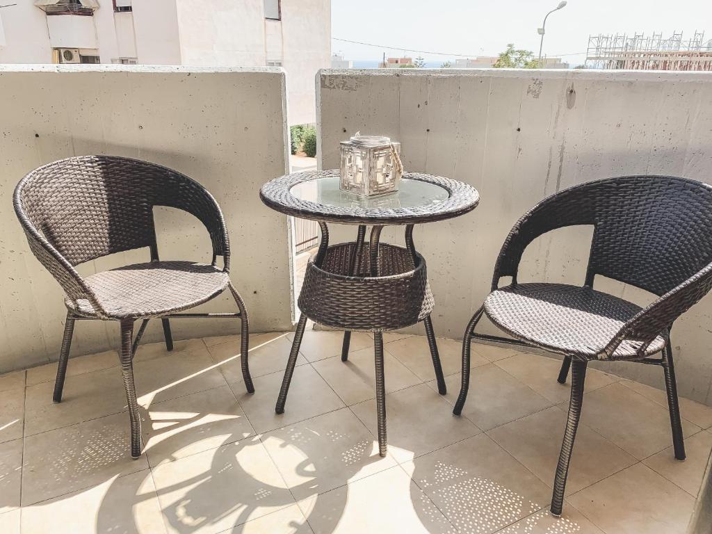 two chairs and a table on a balcony with a table and two chairs at Flat 291 in Polignano a Mare