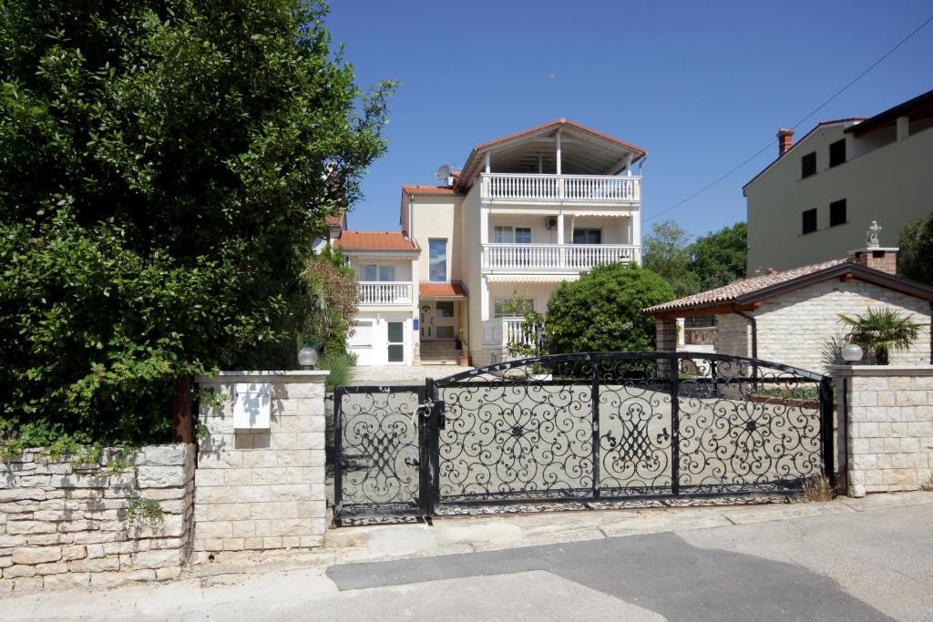an iron gate in front of a house at Apartments Domic in Banjole