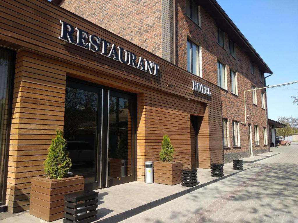 a restaurant with a sign on the front of a building at Бутик-Отель "Zeytun" in Izmail