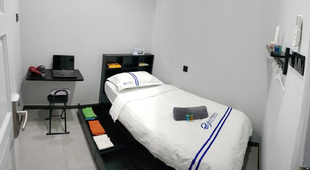 Postel nebo postele na pokoji v ubytování Global Residency