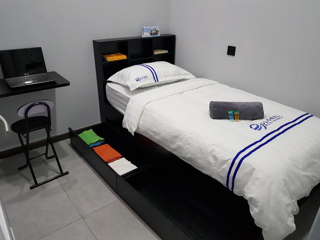 Postel nebo postele na pokoji v ubytování Global Residency