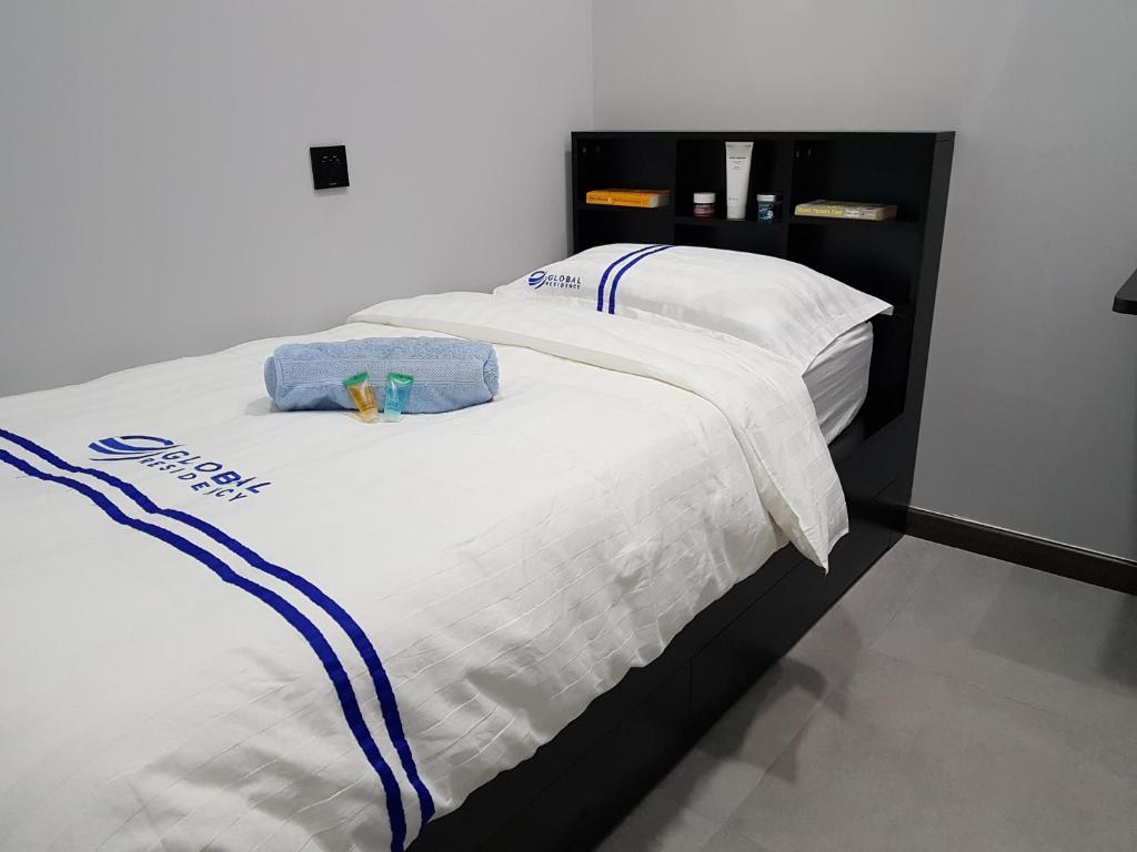 Postel nebo postele na pokoji v ubytování Global Residency