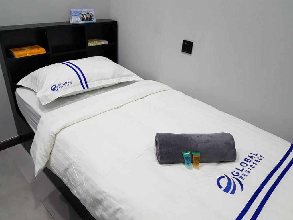 Postel nebo postele na pokoji v ubytování Global Residency
