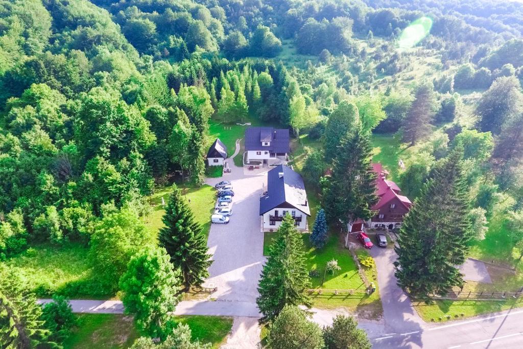 an aerial view of a house in the middle of a forest at B&B Lady of the Lake in Jezerce