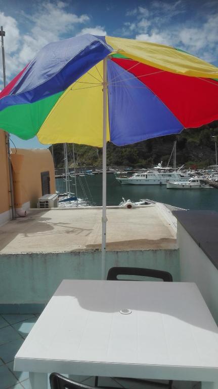 a rainbow colored umbrella sitting on top of a table at Casa Cucurullo in Procida