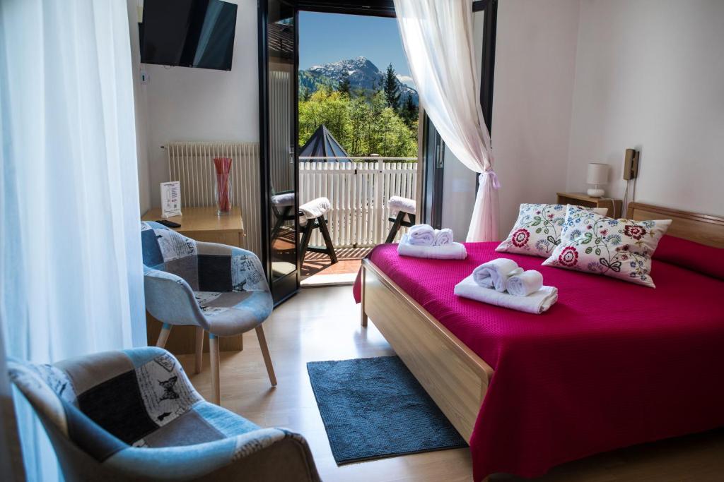 a bedroom with a bed with two towels on it at Hotel Park Oasi in Arta Terme