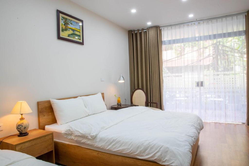 Postel nebo postele na pokoji v ubytování Picturesque Hanoi Homestay