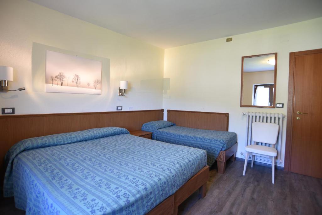 Posteľ alebo postele v izbe v ubytovaní Albergo Bucaneve