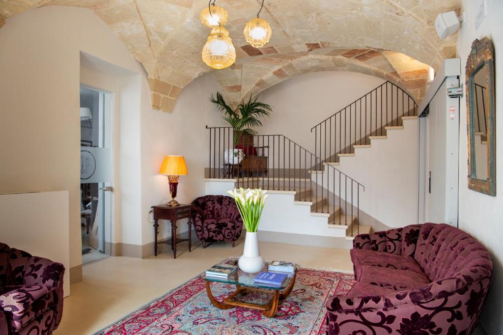 a living room with a couch and a table at I Bastioni San Domenico - Boutique Hotel in Gallipoli