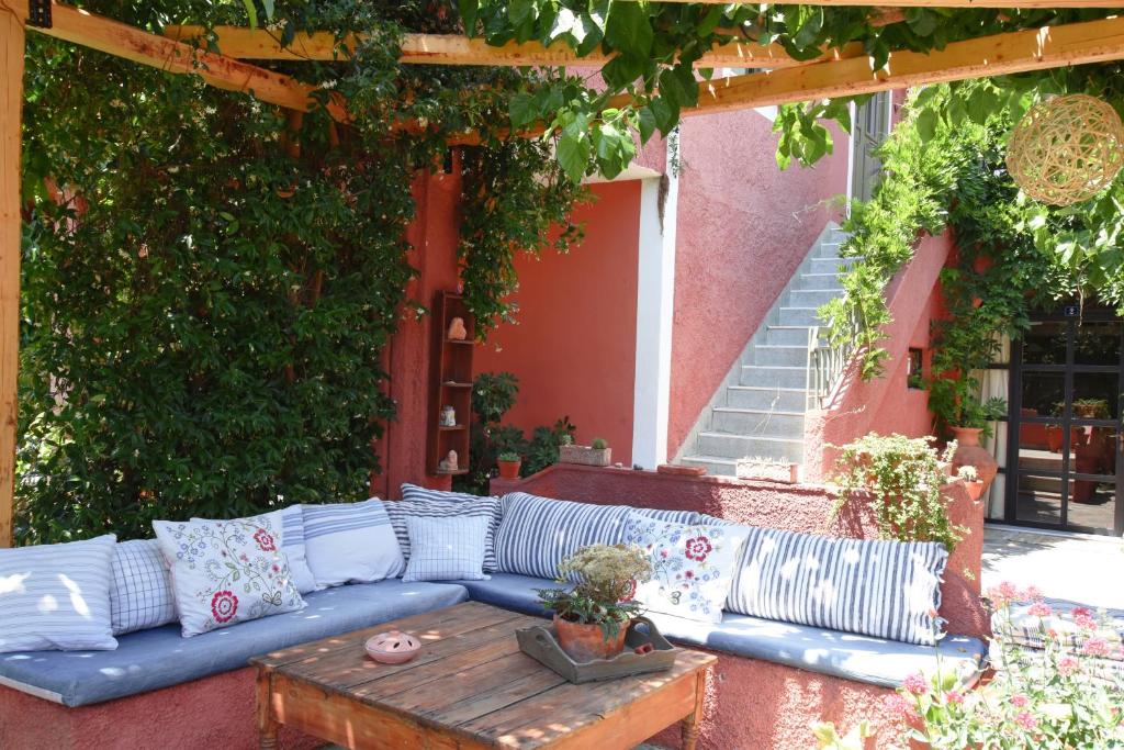 a blue couch on a patio with a wooden table at Zacharoulas Katikies in Amarynthos