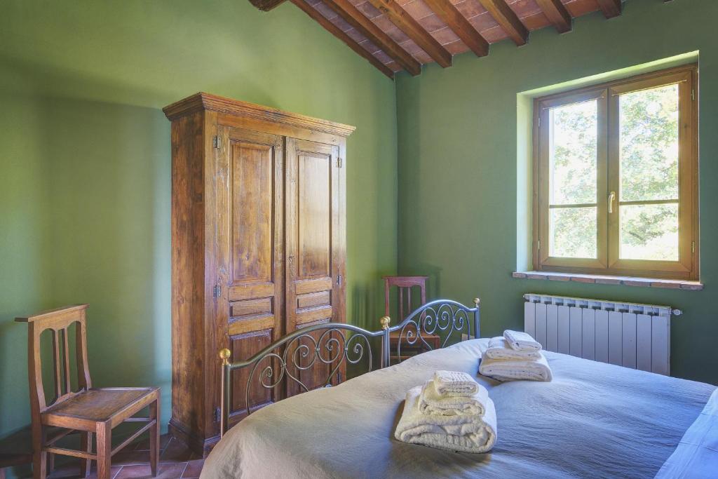 Postel nebo postele na pokoji v ubytování Palazzo Gatteschi