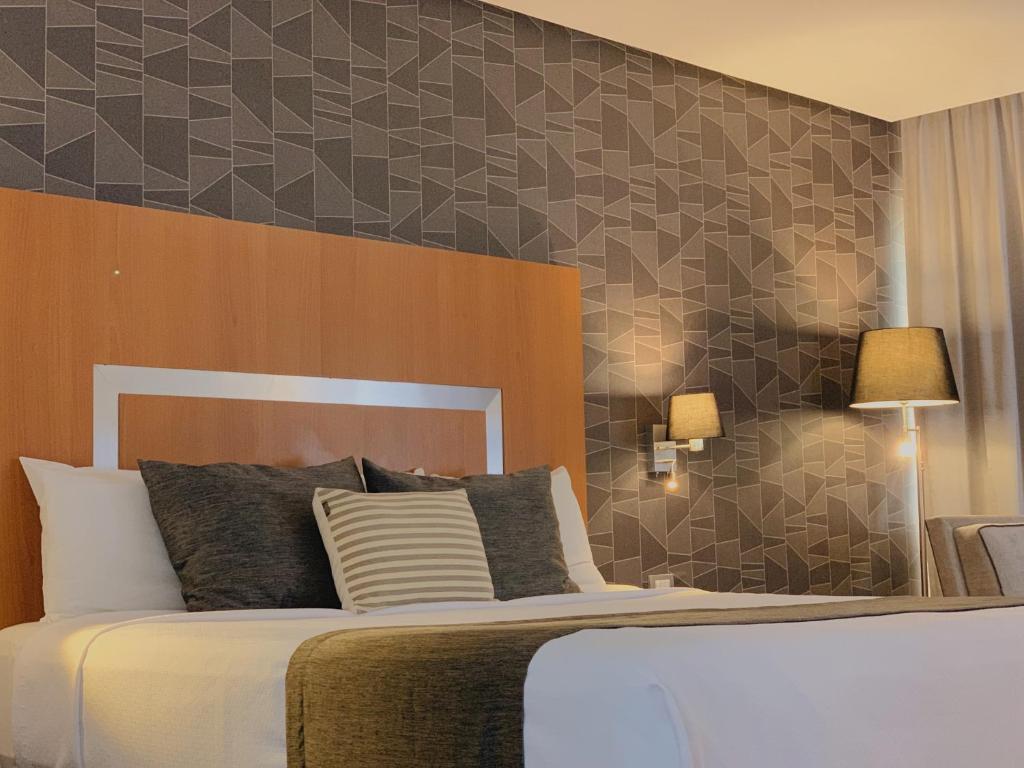 Postel nebo postele na pokoji v ubytování Hotel Mercury Inn
