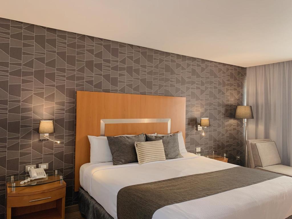 Postel nebo postele na pokoji v ubytování Hotel Mercury Inn