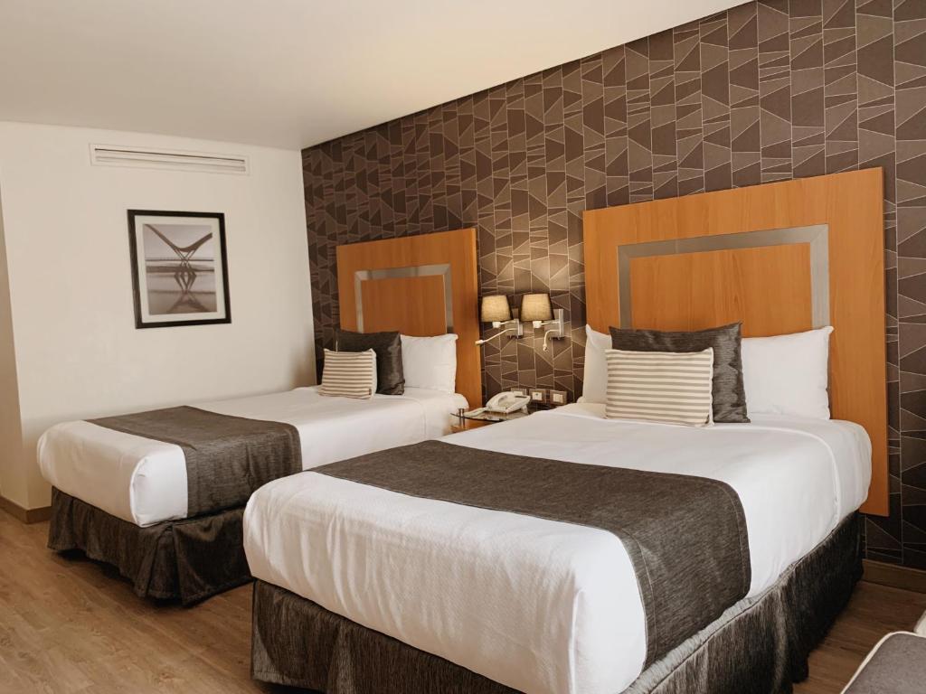 Postel nebo postele na pokoji v ubytování Hotel Mercury Inn