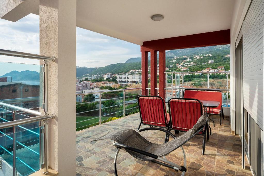 a balcony with chairs and a view of a city at Apartments Vila A1 in Dobra Voda