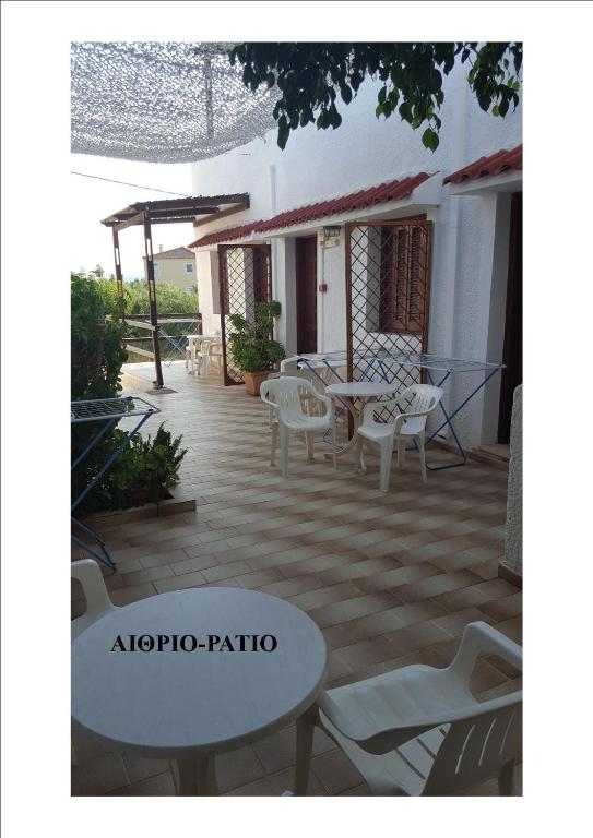 a patio with a table and chairs and a table at Aeolos Hotel Apartments in Gythio