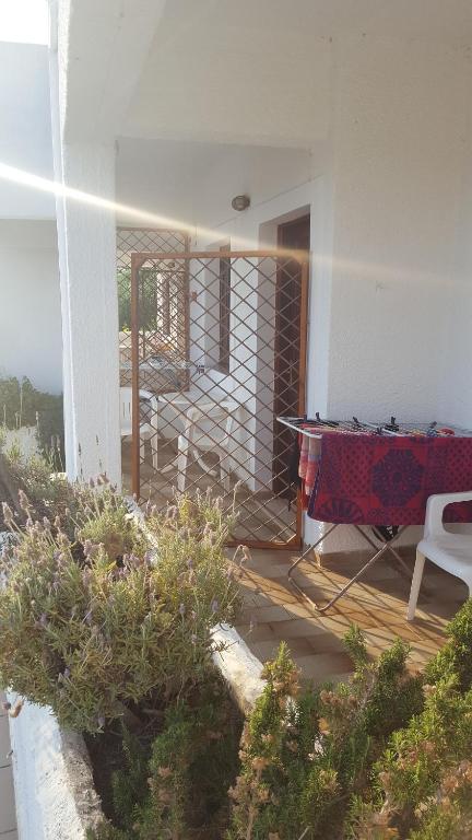 a house with a table and chairs on a porch at Aeolos Hotel Apartments in Gythio