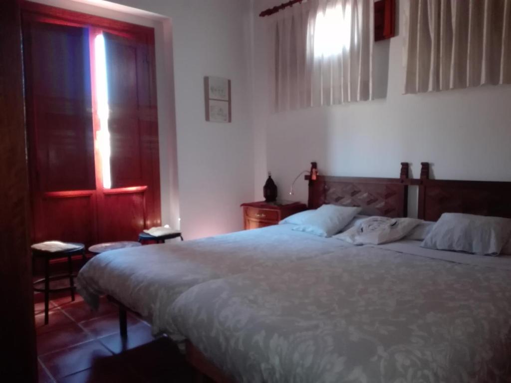 a bedroom with a large bed and a window at La Casa de la Vila in Ontinyent