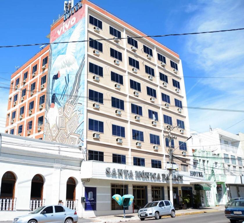 a large building with a mural on the side of it at Santa Mônica Palace Hotel in Corumbá