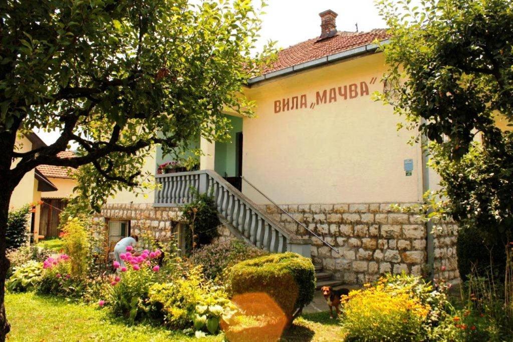 a building with a sign on the side of it at Apartments and rooms Villa Mačva - Banja Koviljača in Banja Koviljača