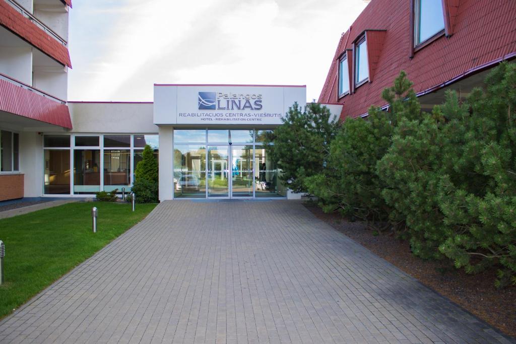 a building with a sign on the front of it at Palangos Linas in Palanga
