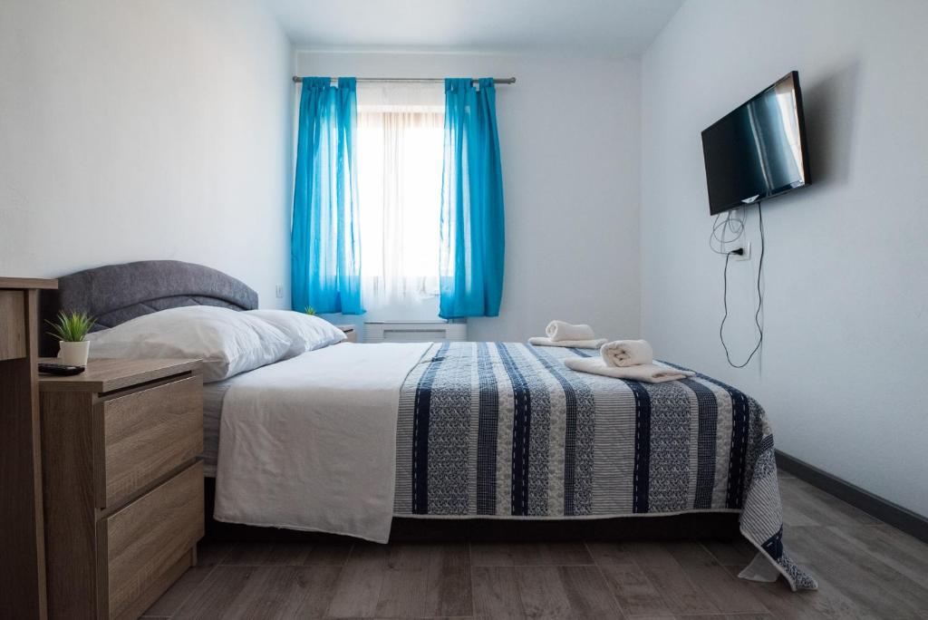 Postel nebo postele na pokoji v ubytování Apartments MARIO