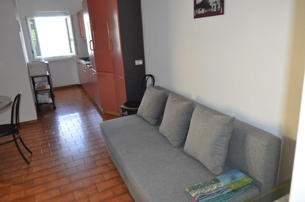 a living room with a gray couch and a table at Holiday home near Monte Baldo in Tremosine Sul Garda in Tremosine Sul Garda