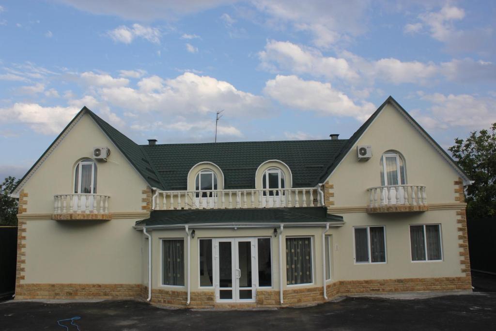 a house with a balcony on top of it at Zhara Hotel in Pyatigorsk