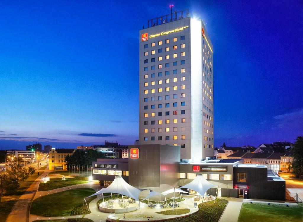 a tall building with a lot of tables in front of it at Clarion Congress Hotel České Budějovice in České Budějovice