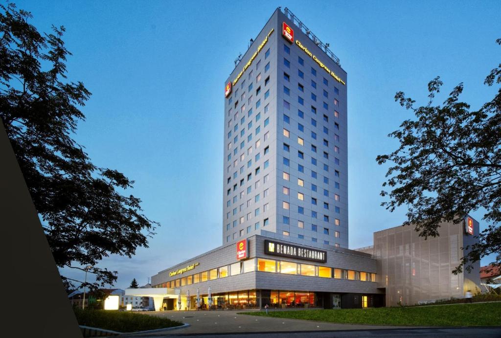 a tall building with a sign on top of it at Clarion Congress Hotel České Budějovice in České Budějovice