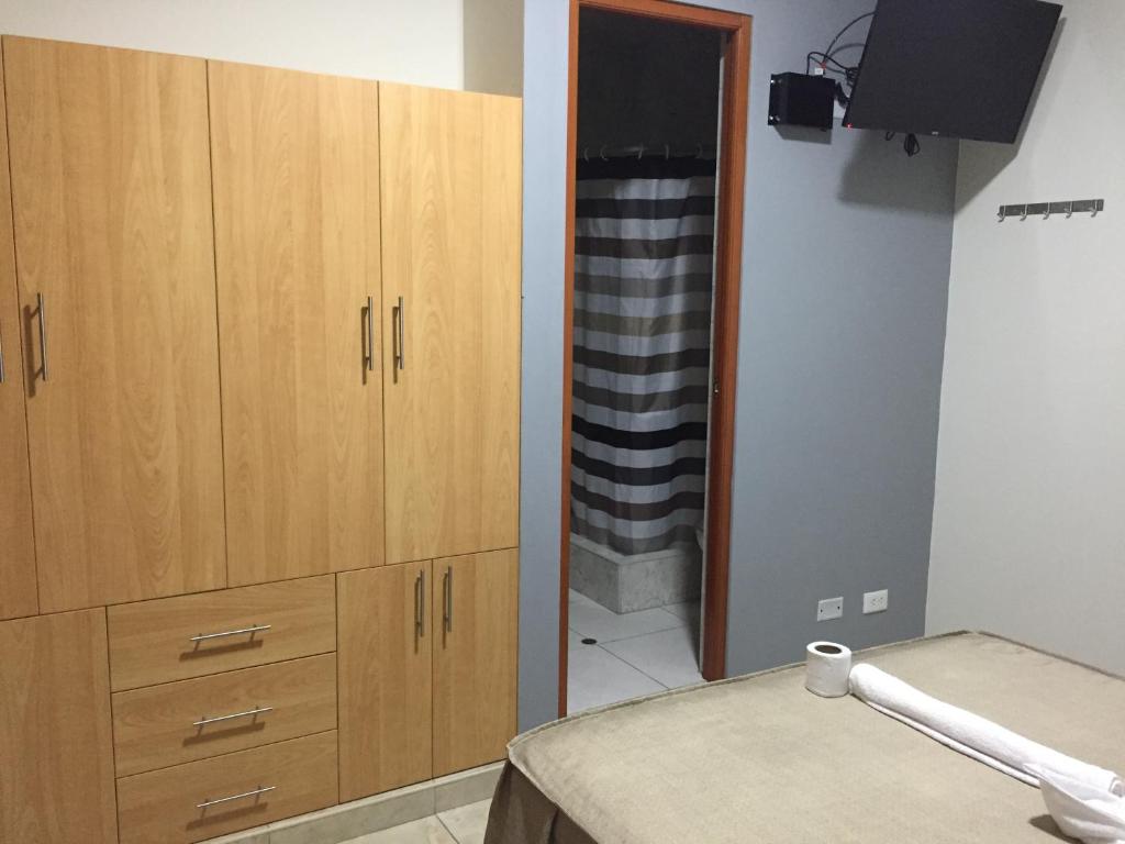 Postel nebo postele na pokoji v ubytování Hostal Parisuite