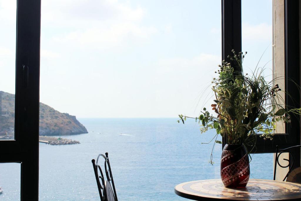 a table with a vase with a plant on it at Hotel Palinuro in Palinuro