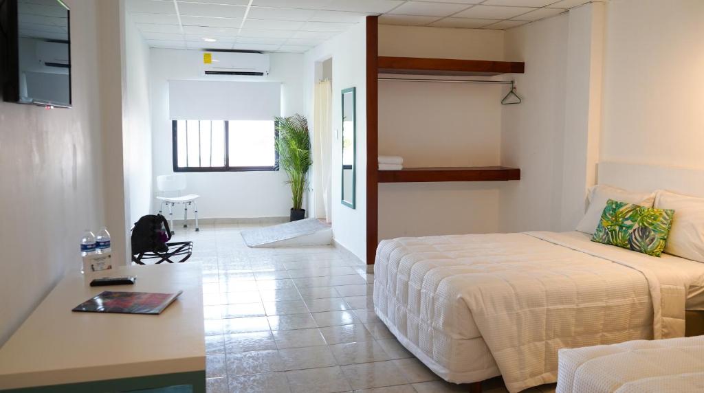 Postel nebo postele na pokoji v ubytování Hotel & Suites Arges - Centro Chetumal