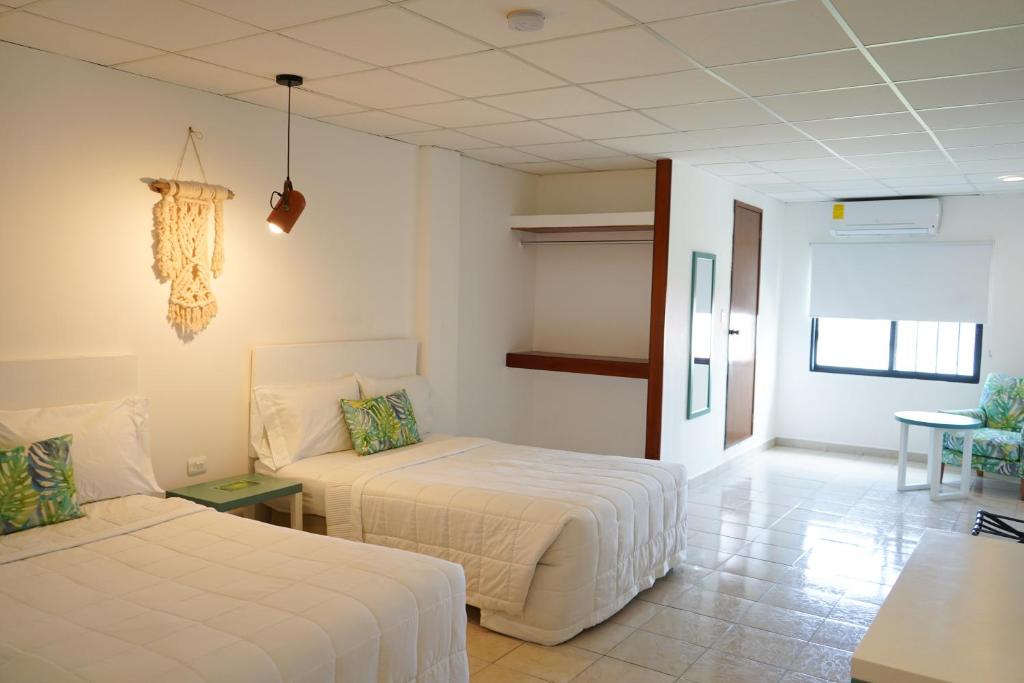 Postel nebo postele na pokoji v ubytování Hotel & Suites Arges - Centro Chetumal